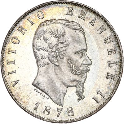 une pièce d'argent sur laquelle figurent le visage et la moustache d'un homme