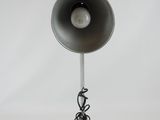 a lamp that is on top of a metal stand