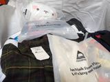 a pile of clothing that is sitting on a couch