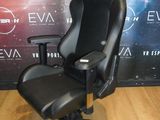 a black office chair sitting on a hard wood floor