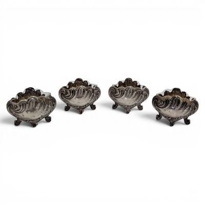 three silver plated bowls with handles on wheels on a white surface