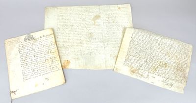 three pieces of paper with writing on them sitting on a table
