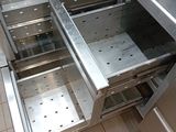 a stainless steel counter top with a drawer in it