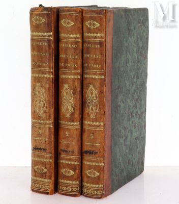 three old books sitting on top of each other on a table