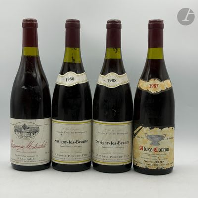 quatre bouteilles de vin sont alignées sur une surface blanche