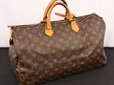 a louis vuittou bag sitting on a black surface