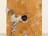 a marble block with a hole in it on a table