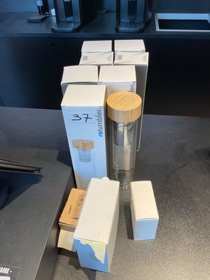 boxes of coffee sit on a counter next to a coffee maker