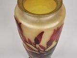 a vase that has a yellow and red flower on it
