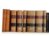 several old books are lined up on a shelf in front of a white background