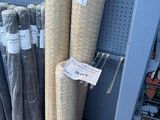 many rolls of fabric on the shelf in the store