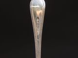 a silver plate with a fork and spoon on it