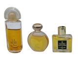 two bottles of perfume sitting next to each other on a white surface