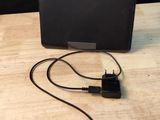a laptop and a charger sitting on a wooden table
