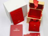 a red box with a red ribbon and a red card in it