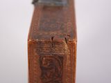 a small wooden box with a metal handle on it