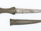 pair of old knifes on a white surface with a white background
