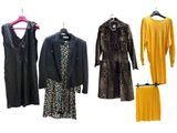 several different types of dresses and jackets hanging on a clothes rack