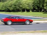 a red and black car driving down the road