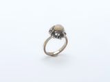 a close up of a silver ring with a skull on it