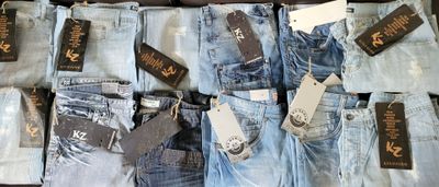 many pairs of jeans that are on display in a store