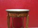 a small wooden table with a marble top on it