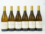 six bouteilles de vin sont alignées sur une surface blanche