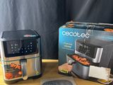 a box of food sitting on a table next to an air fryer
