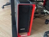 a red and black computer tower on the floor