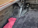 a red umbrella sitting in the trunk of a car