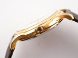 a close up of a watch on a white surface with a white background