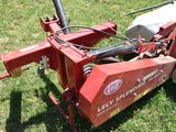an image of a red lawn mower on the grass