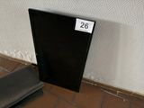 a black door with a number on it next to a wall
