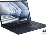 a close up of a laptop on a white surface with a blue background