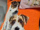 two pillows with dogs on them sitting on a table