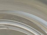 a close up of a silver plate with a name on it