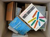 many books in a box that are sitting on top of each other