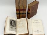 three old books sitting on top of each other on a table