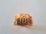 an image of a gold ring with a picture of a man ' s face on it