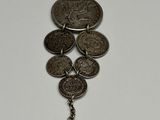 a close up of a bunch of coins hanging from a chain