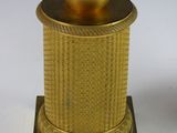 a gold clock with a statue on top of it