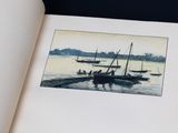 an open book with a picture of boats on the water