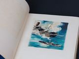 an open book with a picture of two ships in the water
