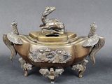 an image of a bronze incense box with a bird on top