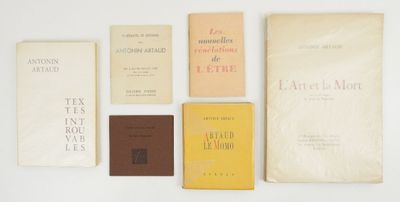 several books are lined up on a white surface