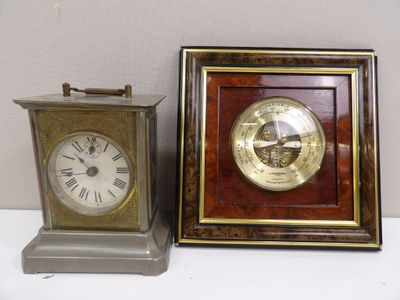 two clocks sitting next to each other on a table