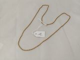 a close up of a gold chain with a price tag on it