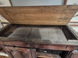 an old wooden cabinet with a drawer on top of it