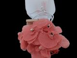 a pink flower with a ring in it on a black background