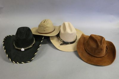 several hats are lined up on a table with a white background